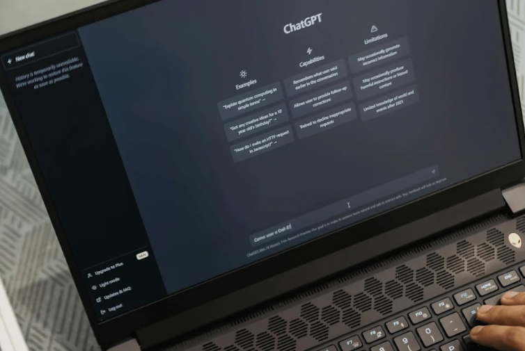 Laptop screen displaying the ChatGPT interface with examples and capabilities.